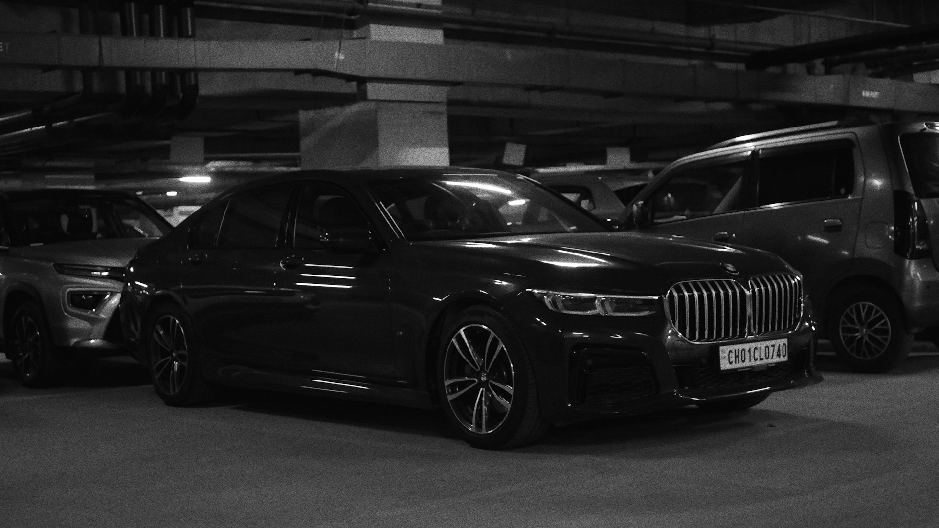 several cars parked in a parking garage next to each other